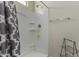 Bright bathroom with a gray patterned shower curtain and white shower stall at 3026 N 305Th Dr, Buckeye, AZ 85396