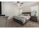 Comfortable bedroom with neutral decor, ample natural light, and a ceiling fan at 3026 N 305Th Dr, Buckeye, AZ 85396