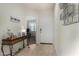 Bright entryway with neutral tile flooring, a decorative table, and a view into the next room at 3026 N 305Th Dr, Buckeye, AZ 85396