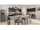 Granite countertops highlight the kitchen island with seating and modern appliances at 3026 N 305Th Dr, Buckeye, AZ 85396
