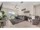 Bright living space with neutral tile, a comfortable sectional sofa, and access to outdoor patio at 3026 N 305Th Dr, Buckeye, AZ 85396