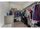 Well-organized walk-in closet with shelving and rods for clothing and shoes at 3026 N 305Th Dr, Buckeye, AZ 85396