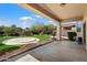 Backyard features a covered patio, lush landscaping, and a built-in barbeque area at 4416 W Magellan Dr, New River, AZ 85087