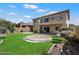 Spacious backyard featuring green lawn, desert landscaping, and unique concrete patio at 4416 W Magellan Dr, New River, AZ 85087