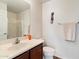Well-lit bathroom featuring a single vanity sink, a large mirror, and a shower-tub combination at 4416 W Magellan Dr, New River, AZ 85087