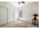 Neutral bedroom features a ceiling fan, a window and a storage closet with sliding doors at 4416 W Magellan Dr, New River, AZ 85087