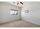 Cozy bedroom featuring a ceiling fan and a window with a view of the outdoors at 4416 W Magellan Dr, New River, AZ 85087