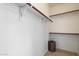 Walk-in closet with wooden shelving and a convenient woven basket for storage at 4416 W Magellan Dr, New River, AZ 85087