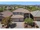 Two-story home with a tile roof, three-car garage, and desert landscaping at 4416 W Magellan Dr, New River, AZ 85087