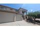 Lovely front exterior featuring a three car garage, desert landscaping, and a welcoming covered entry at 4416 W Magellan Dr, New River, AZ 85087