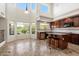 Bright kitchen with large windows, stainless steel appliances, and a convenient center island with barstool seating at 4416 W Magellan Dr, New River, AZ 85087