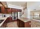 Bright kitchen featuring stainless steel appliances, granite countertops, and stylish dark wood cabinets at 4416 W Magellan Dr, New River, AZ 85087