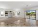 Spacious living room featuring built-in shelving, tile flooring, and a sliding glass door at 4416 W Magellan Dr, New River, AZ 85087