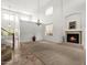 Open-concept living room boasting high ceilings, a cozy fireplace, and large windows for ample natural light at 4416 W Magellan Dr, New River, AZ 85087