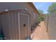 View of backyard shed and gravel pathway along the side of the house at 4609 W Challenger Trl, New River, AZ 85087