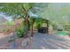 Well-manicured backyard featuring a sitting area and various trees and flowers at 4609 W Challenger Trl, New River, AZ 85087