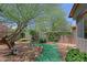 Spacious backyard with mature trees, decorative turf, and a tranquil seating area at 4609 W Challenger Trl, New River, AZ 85087