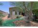 The spacious backyard features an artificial grass border, rock details, and covered patio at 4609 W Challenger Trl, New River, AZ 85087