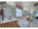 Spacious bathroom featuring double sinks, a soaking tub, and a separate shower at 4609 W Challenger Trl, New River, AZ 85087