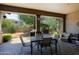 Covered patio with view of the yard featuring neutral colored furniture and brick pavers at 4609 W Challenger Trl, New River, AZ 85087
