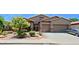 Single Gathering home with manicured front yard, two car garage and desert landscaping at 4609 W Challenger Trl, New River, AZ 85087