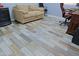 Wood-look plank flooring in office room featuring a desk, sofa and bureau at 4609 W Challenger Trl, New River, AZ 85087