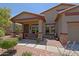 Inviting covered front porch with decorative columns and a secured front door at 4609 W Challenger Trl, New River, AZ 85087
