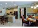 Bright, open kitchen with a center island, stainless steel appliances, and adjacent dining area at 4609 W Challenger Trl, New River, AZ 85087