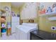 Laundry room with white washer and dryer, cabinets and a refrigerator at 4609 W Challenger Trl, New River, AZ 85087