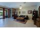 Spacious living room featuring neutral paint, tile floors, and access to the backyard at 4609 W Challenger Trl, New River, AZ 85087