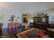 Open living area with wood floors and arched doorway; neutral paint and filled with furniture at 4609 W Challenger Trl, New River, AZ 85087