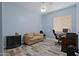 Office with blue walls, plank flooring, a sofa, and a desk at 4609 W Challenger Trl, New River, AZ 85087