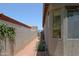 View of side yard, showing privacy wall, desert landscaping, and exterior windows at 4609 W Challenger Trl, New River, AZ 85087