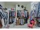 Large walk-in closet features built-in shelving, hanging rods, and ample storage space for organization at 4609 W Challenger Trl, New River, AZ 85087