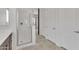 Bright bathroom featuring a glass shower, tile floors, and a neutral color palette at 4866 N 185-Th Dr, Goodyear, AZ 85395