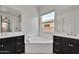 Bathroom featuring double vanities and a soaking tub at 4866 N 185-Th Dr, Goodyear, AZ 85395