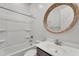 Bright bathroom with round mirror and modern vanity at 4866 N 185-Th Dr, Goodyear, AZ 85395