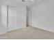Bedroom with carpet flooring features sliding closet doors with an ensuite at 4866 N 185-Th Dr, Goodyear, AZ 85395