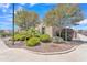 Well-maintained front yard with desert landscaping, mature trees, and a glimpse of the charming single-story home at 4866 N 185-Th Dr, Goodyear, AZ 85395