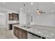 Kitchen island with stainless steel sink and granite countertop, perfect for food preparation and entertaining at 4866 N 185-Th Dr, Goodyear, AZ 85395