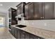 Modern kitchen features sleek dark cabinetry and stainless steel appliances at 4866 N 185-Th Dr, Goodyear, AZ 85395