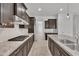 Well-appointed kitchen featuring dark wood cabinetry, granite countertops, and stainless steel appliances at 4866 N 185-Th Dr, Goodyear, AZ 85395