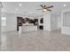 Open-concept kitchen featuring dark wood cabinets, a large island, and stainless steel appliances at 4866 N 185-Th Dr, Goodyear, AZ 85395