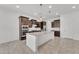 Modern kitchen featuring a center island, dark cabinets, and stainless steel appliances, offering style and function at 4866 N 185-Th Dr, Goodyear, AZ 85395