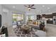Open-concept living room flows into the kitchen, featuring modern furnishings and natural light at 4866 N 185-Th Dr, Goodyear, AZ 85395