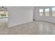 Bright living room with tile flooring and large windows providing natural light; blank canvas for personalization at 4866 N 185-Th Dr, Goodyear, AZ 85395