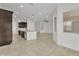 Open-concept living room and kitchen with tile floors and neutral decor at 4866 N 185-Th Dr, Goodyear, AZ 85395