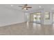 Bright living space featuring sliding glass doors to the patio, ceiling fan, and tile floors at 4866 N 185-Th Dr, Goodyear, AZ 85395