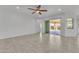 Bright living room with tile flooring, a ceiling fan, and sliding glass doors that lead to the backyard patio at 4866 N 185-Th Dr, Goodyear, AZ 85395