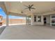 Large covered patio with ceiling fans, recessed lighting, and seamless access to the backyard and kitchen at 4866 N 185-Th Dr, Goodyear, AZ 85395